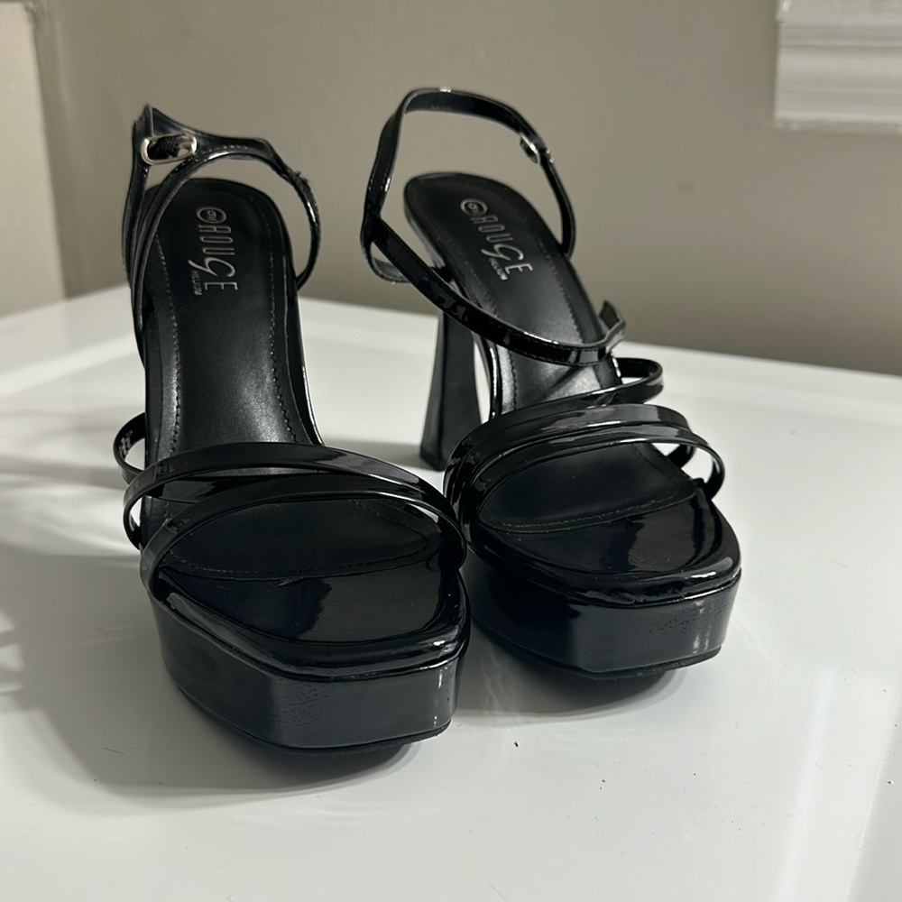 Patent leather platform heel. Never worn. New in box. Size 9.